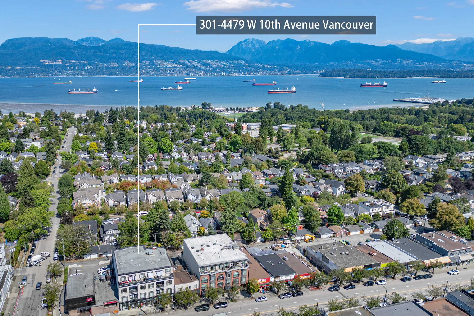 Aerial view over the shops on West 10th toward the water, the building marked