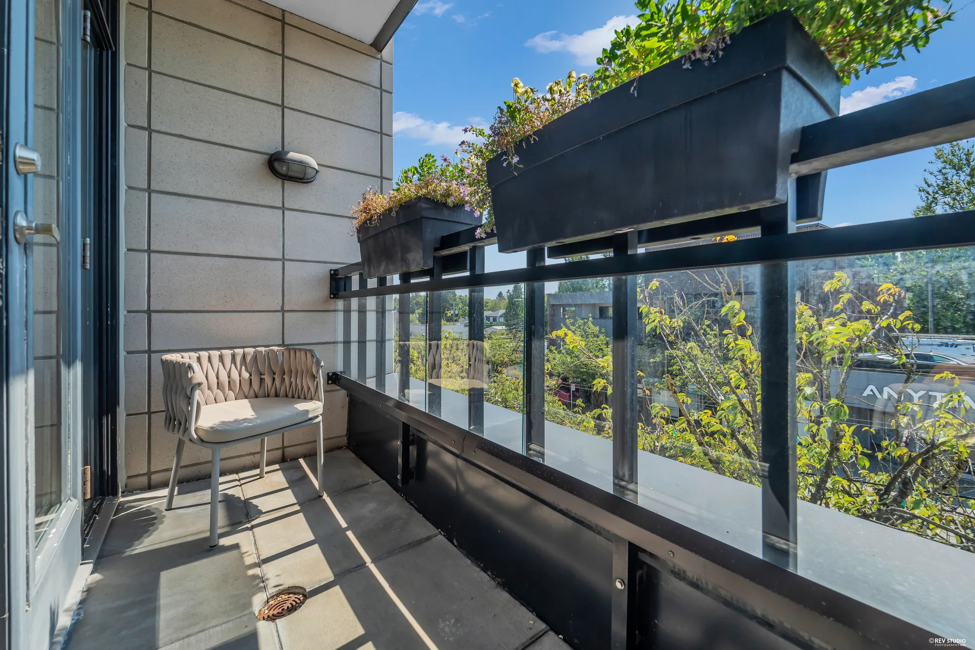 The balcony from the other end, planters and the street below