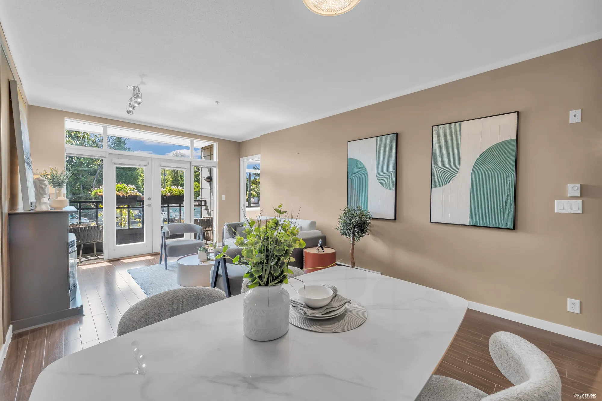 The dining table laid, the balcony doors beyond