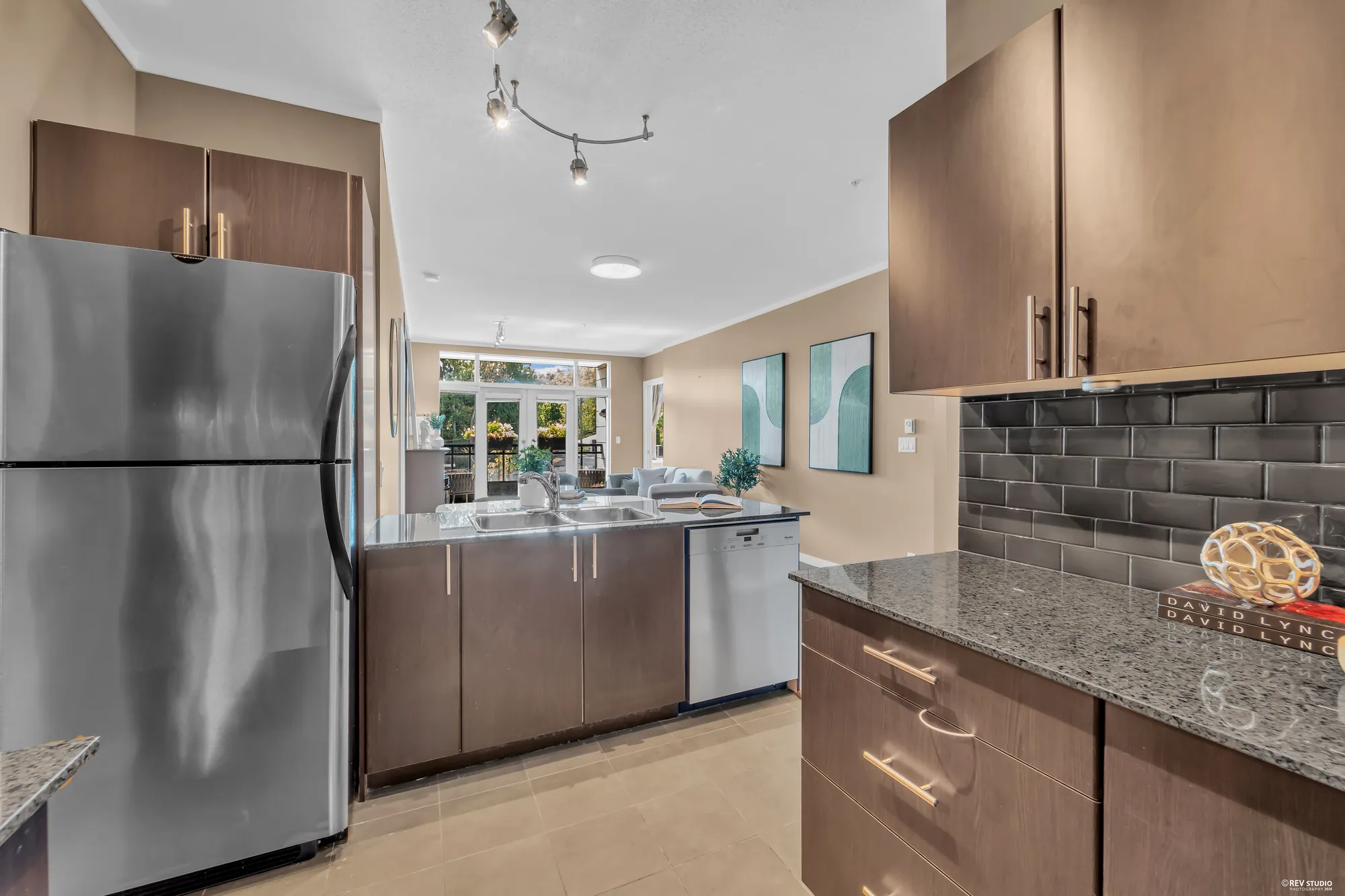 The kitchen from the doorway, fridge and dishwasher along the near wall