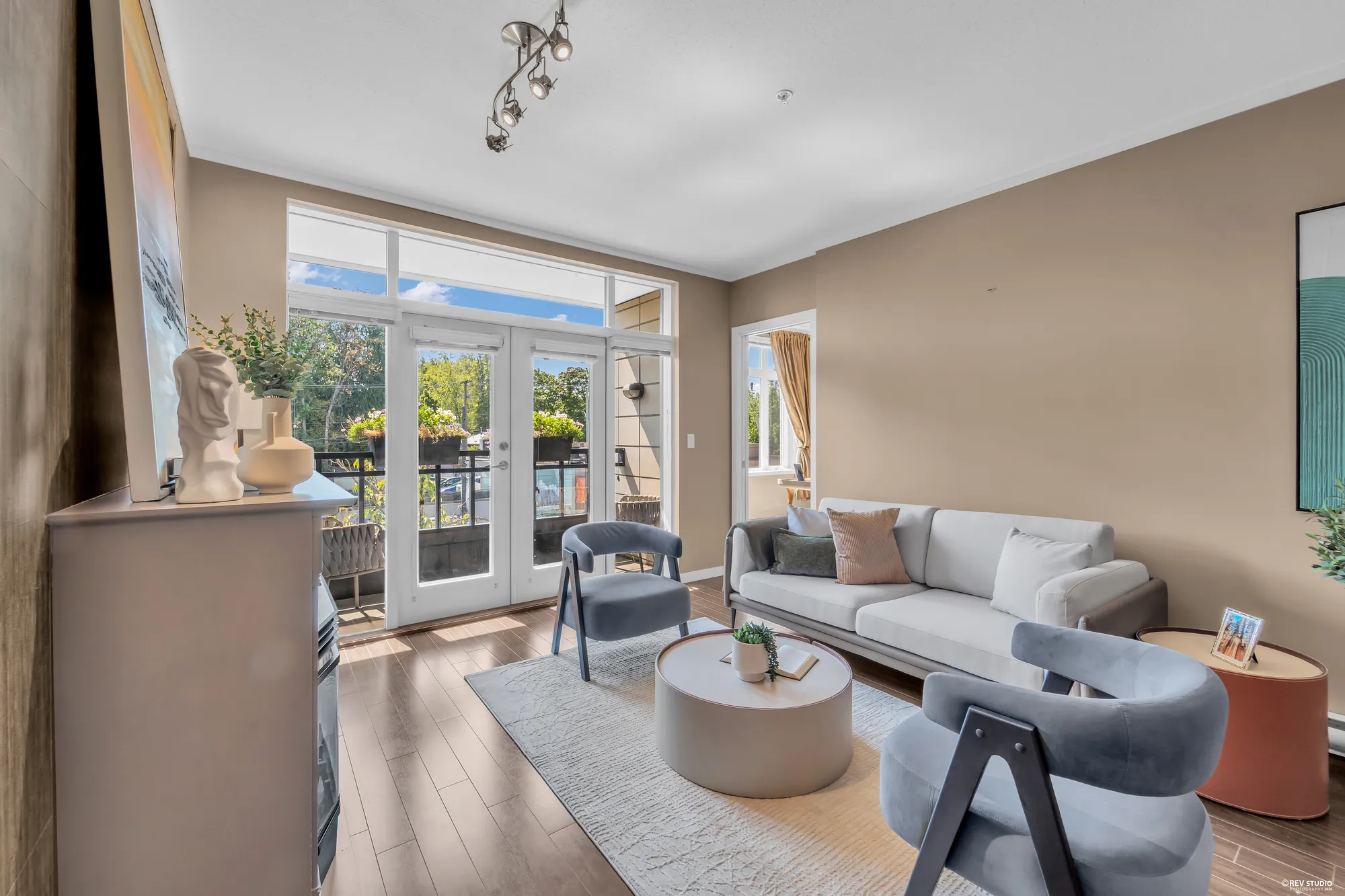 The living room with the balcony doors open to the street