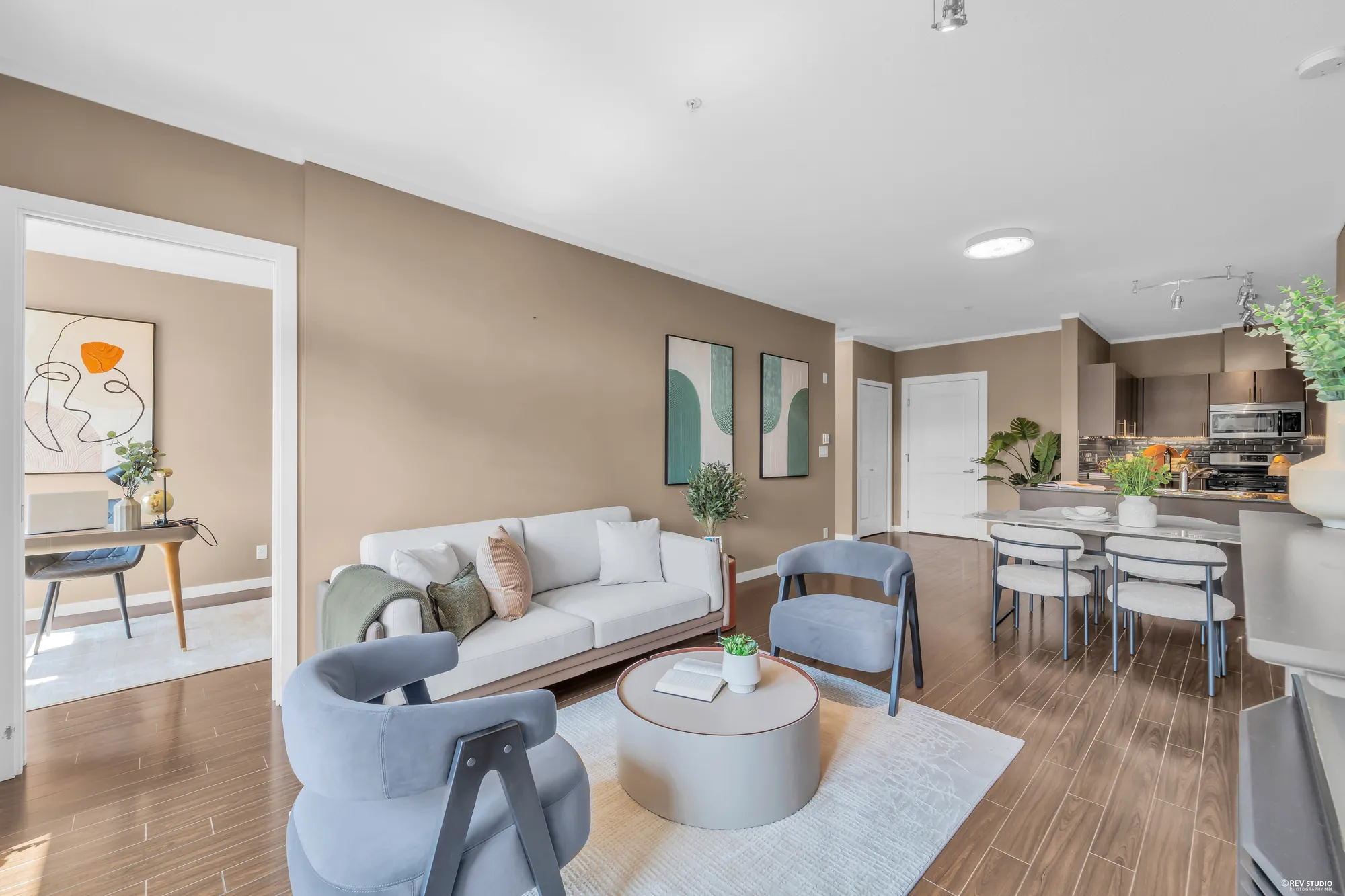 The living room and dining area with the kitchen beyond