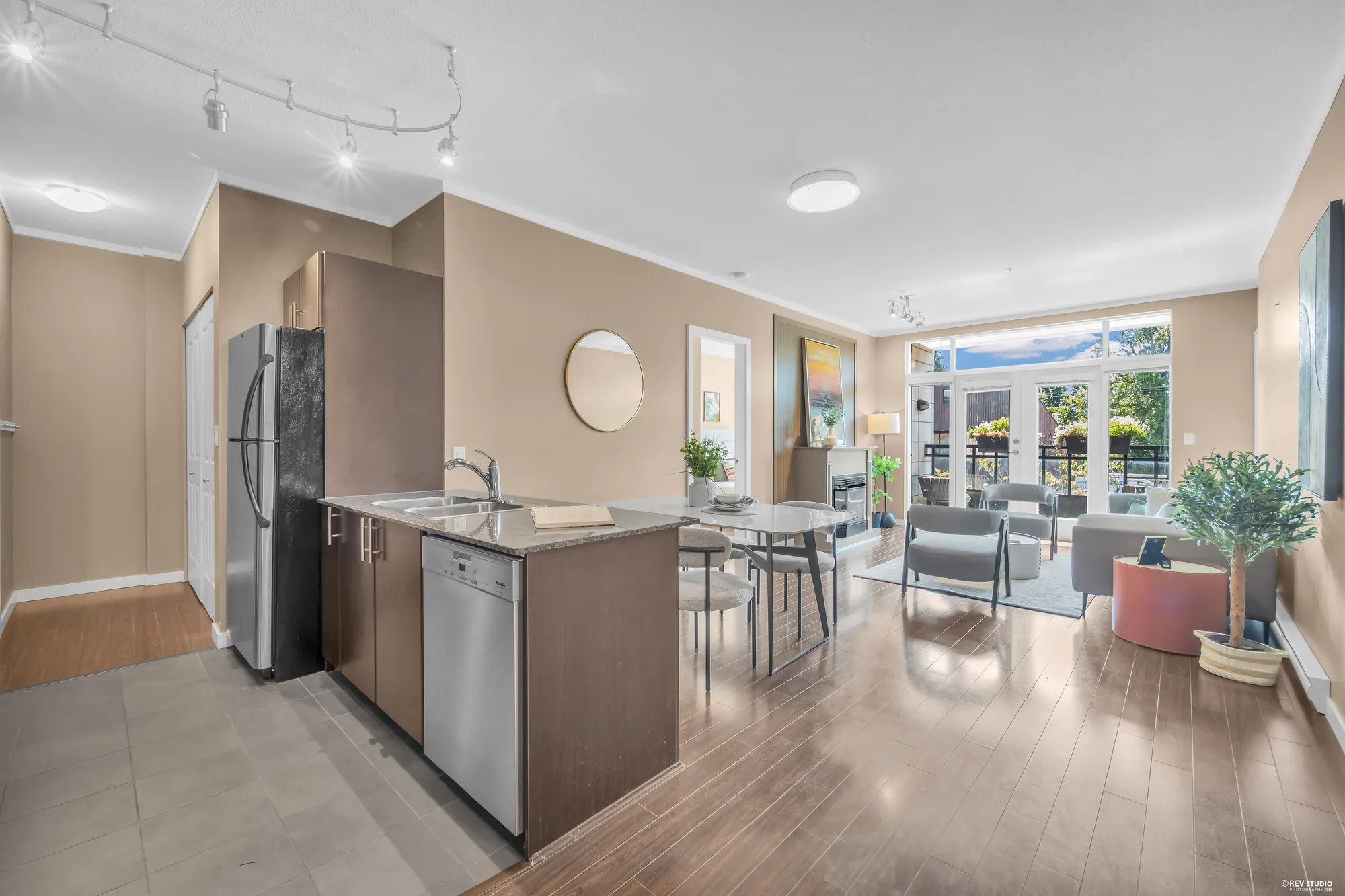 The kitchen, dining and living rooms seen in one view from the foyer end
