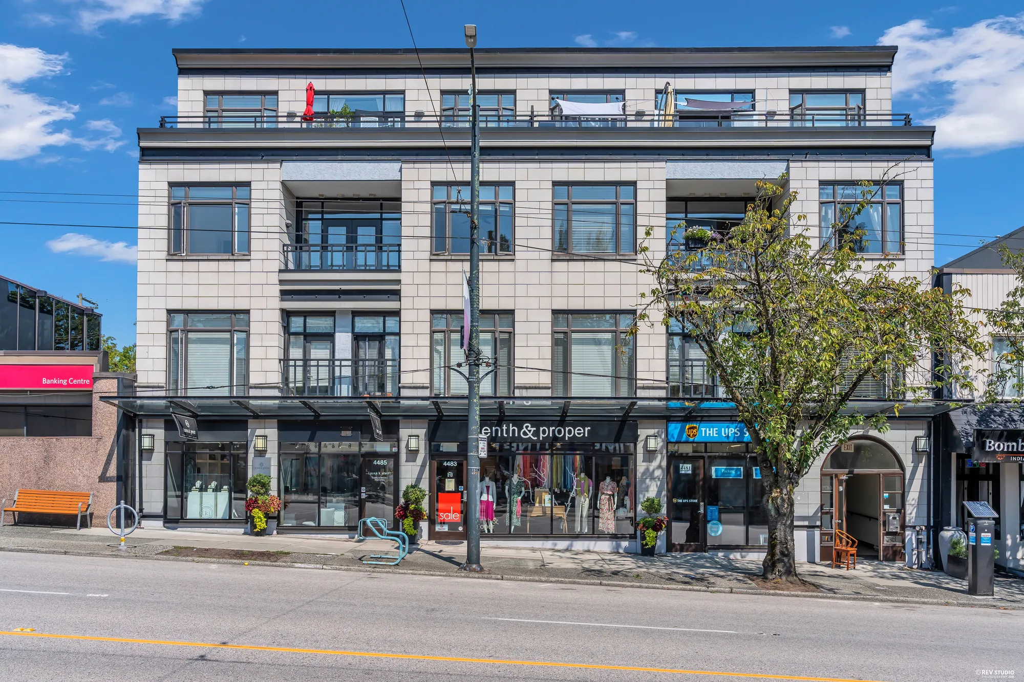 The front of the building at street level, shops along the ground floor