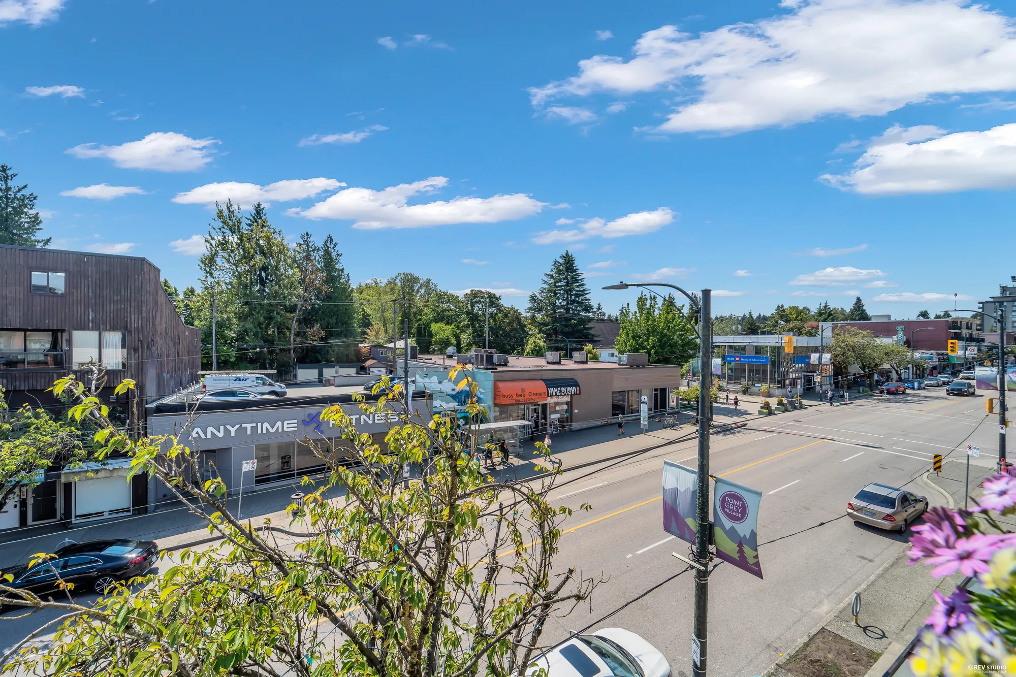 The view along West 10th Avenue from the balcony, shops and street trees below